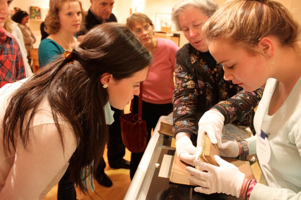 College Archivist Zeph Stickney and students help to display some of the delicate books