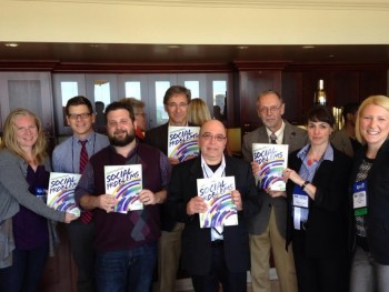 Authors standing, holding text entitled "Social Problems".