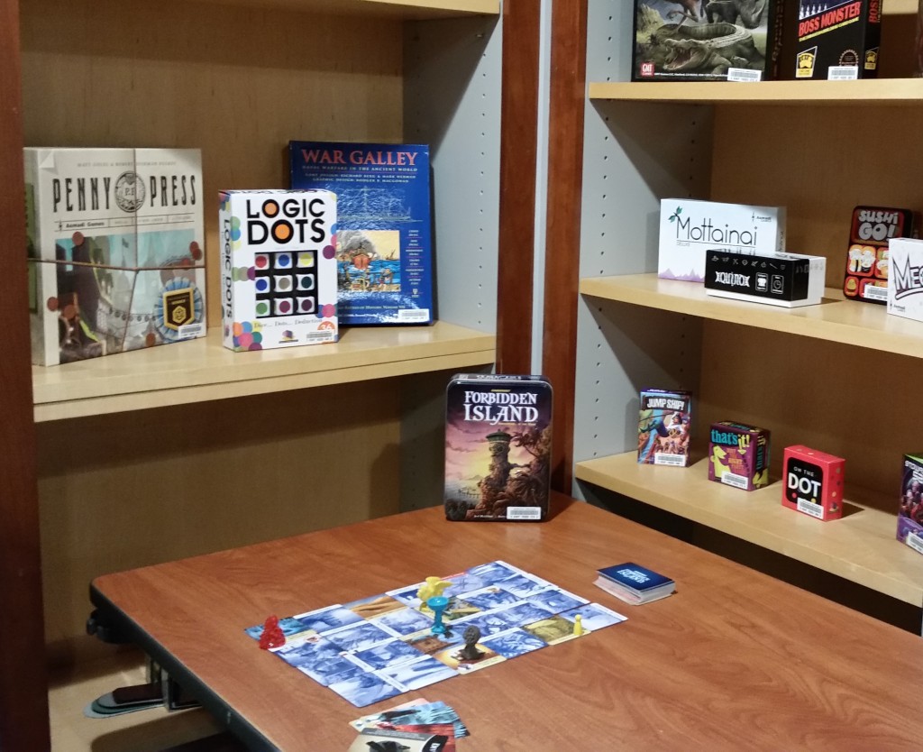 table with game in progress, shelves with games