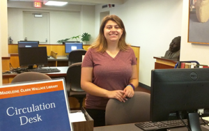 Student employee helping another student at the Wallace Library Information Desk