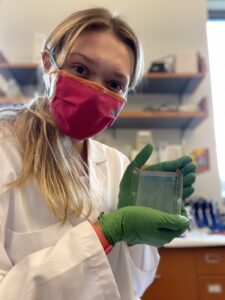 shows Madeleine Lambert running gels in the lab to test genetic sequences.