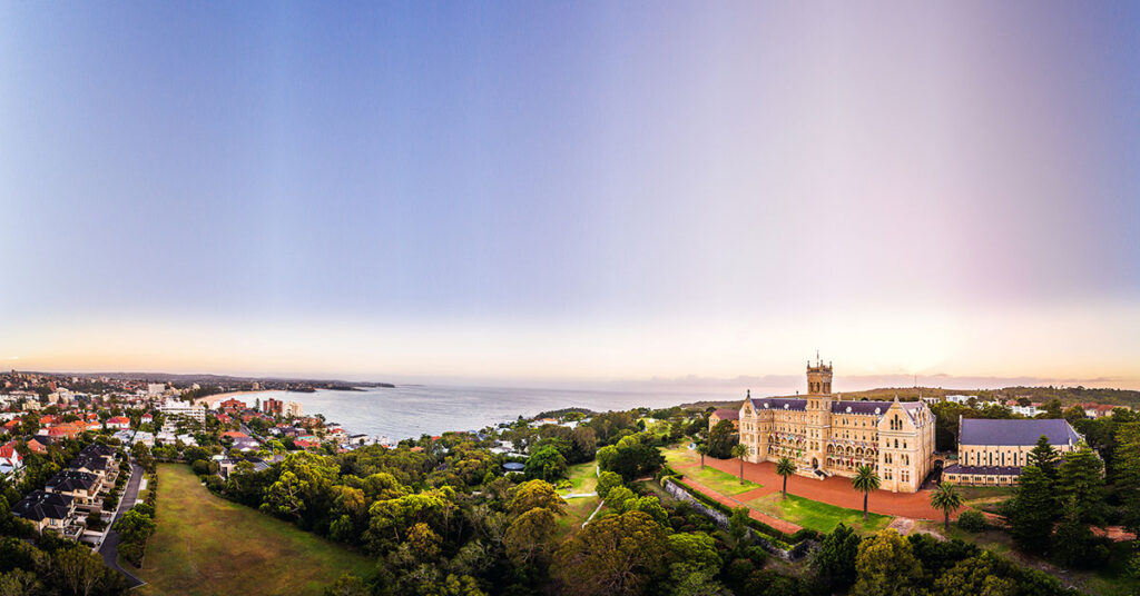 An aerial view of the International College of Management in Sydney, Australia, with buildings close to a body of water.